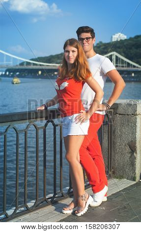 Cute young hipster couple having fun and smiling on a bright day in the city