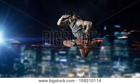 B-boy performing some moves . Mixed media