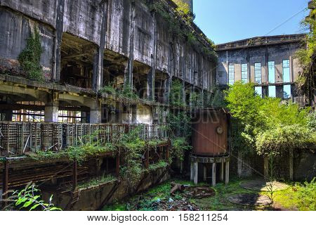 Abandoned, destroyed by war and overgrown machinery of Tkvarcheli (Tquarchal) power plant, Abkhazia, Georgia