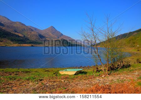 Rowing boat shore of Loch Leven Scottish lake west coast of Scotland in Scottish Highlands west of Kinlochleven and just off B863 south of Ben Nevis