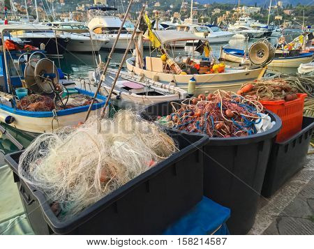 Plastic box full of fishing net, floats, nylon rope used in fishing industry in evening at Tigullio Gulf of Santa Margherita Ligure, Italy