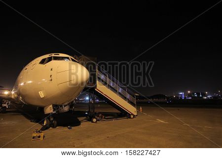 Passenger Airplane at the terminal gate, prepare and maintenance aircraft for night flight