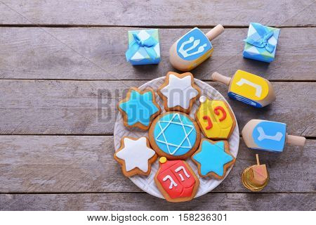 Beautiful composition of tasty cookies for Hanukkah on wooden table