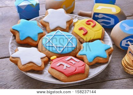 Plate with tasty cookies for Hanukkah on wooden table, closeup