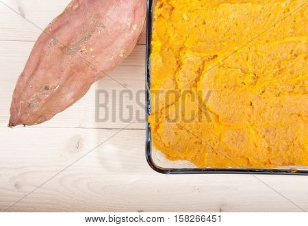 Oven Meal With Sauerkraut And Sweet Potato On Wooden Background