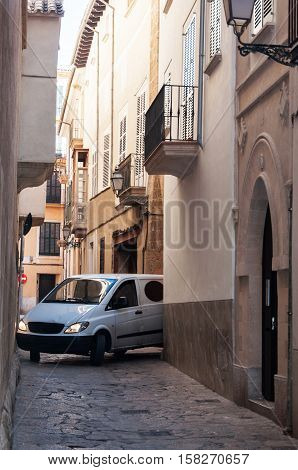 Car in the narrow streets of the old Majorca city Spain