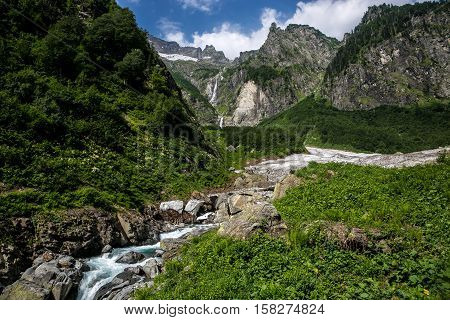 Cool mountain stream flowing from under the glacier. Highland pass in Upper Kodori District near border of Georgia - Abkhazia
