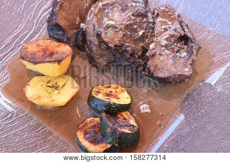 Beef cheek with potatoes, courgette and sauce