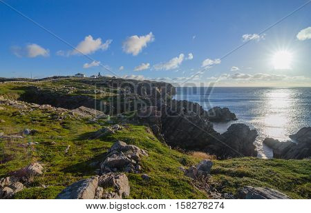 Cape Bona Vista coastline in Newfoundland, Canada.  Lighthouse station atop the end of the cape ahead on the horizon.