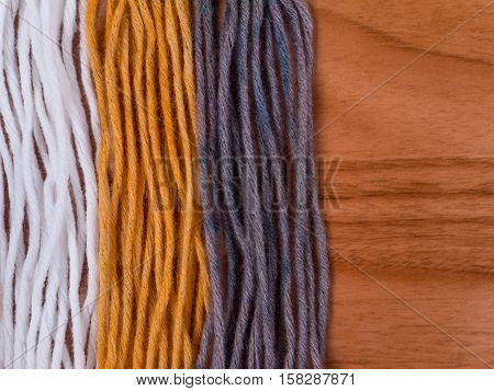Wool yarn swatches colored by henna and indigo and control white sample