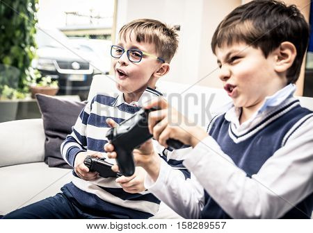 Happy children playing videogames in the living room