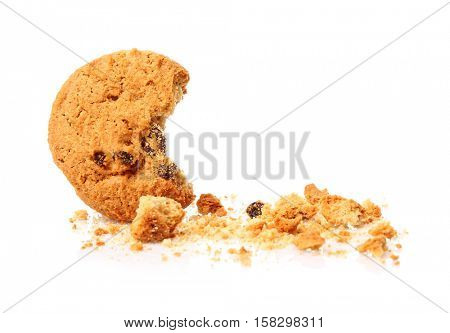 Tasty cookie with chocolate chips and crumbs on white background