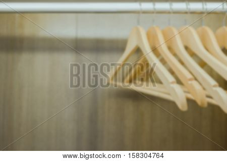 Blurry clothes hanger in wardrobe. Vintage process. Text space available.