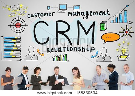 Customer Relationship Concept With Multi-ethnic Businesspeople Standing Below With Laptop And Mobilephone