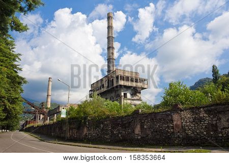The entrance to the city of Tkvarcheli (Tquarchal). View to destroyed by Georgian-Abkhazian war power plant