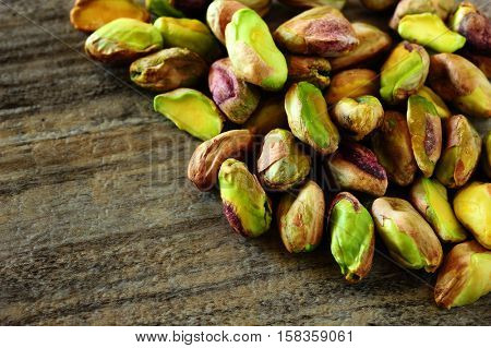 Close-up image of pistachios on wooden background