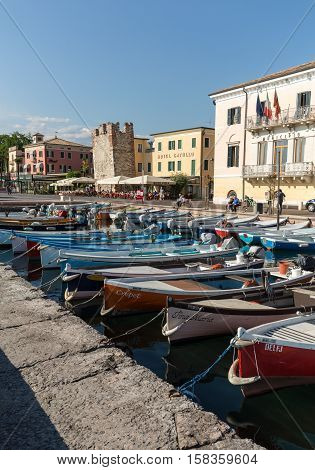 BARDOLINO, ITALY - MAY 4, 2016: Sailboats and fishing boats at Porto di Bardolino harbor on The Garda Lake . Italy