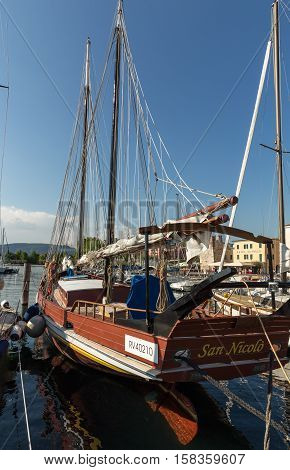 BARDOLINO, ITALY - MAY 4, 2016: Sailboat at Porto di Bardolino harbor on The Garda Lake . Italy