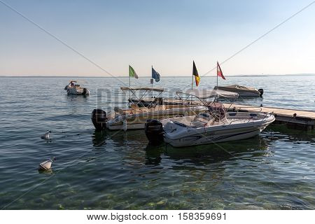 BARDOLINO, ITALY - MAY 4, 2016: Motor boats at Porto di Bardolino harbor on The Garda Lake . Italy