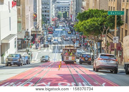 San Francisco, California, United States - August 17, 2016: Cable Car climbs the popular Powell Street hill in the busy central area of Union Square, San Francisco downtown.