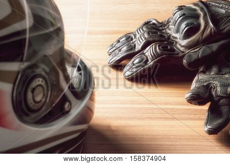 Motorcycle Helmet, Gloves, And Road Maps On A Wooden Table