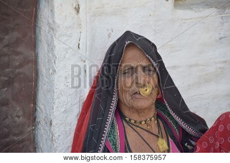 RAJASTHAN, INDIA - FEBRUARY 09, 2016 - Portrait of an unidentified old indian woman from Bishnoi village wearing a big nose stud