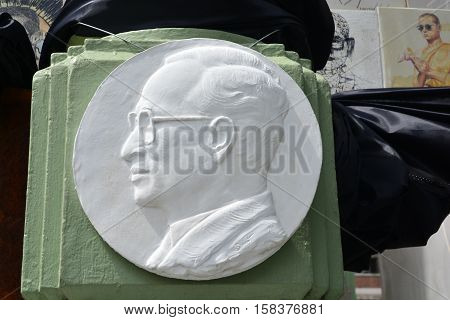 BANGKOK THAILAND - November 162016: plaster Bas relief of His Majesty King Bhumibol portrait at the wall in front of the Pohchang Academy Of Arts to art exposition in Bangkok Thailand.