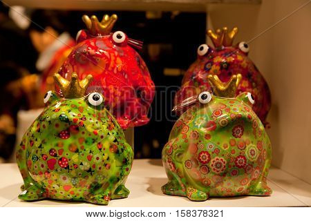 different colored decorative porcelain crowns frog sitting in funny poses