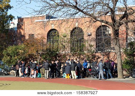 New York, United States of America - November 17, 2016: Chinese people gahering in public park in Chinatown to play games
