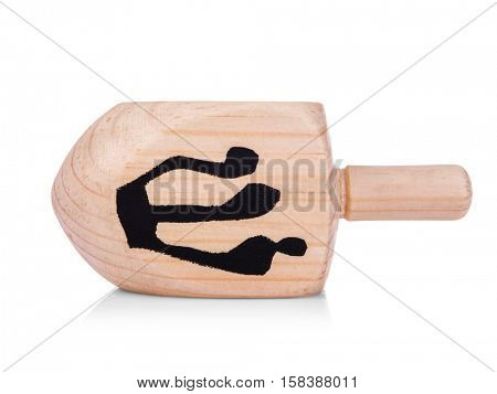 Wooden dreidel for Hanukkah on white background