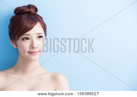 beauty woman look somewhere isolated on bluebackground asian