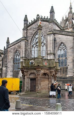 Edinburgh, Scotland, UK- July 18, 2016: The mercat Cross and the Saint Giles' Cathedral on the Royal Mile