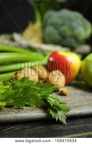 Ingredients for Waldorf salad - celery apples walnuts - fresh and healthy vegetables on granite board.