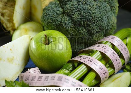 Green vegetables and fruits - celeriac broccoli celery shoots and apples healthy fitness diet concept