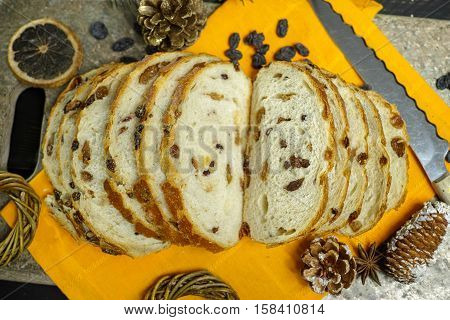 Fresh baked raisins bread sliced on granite board holiday concept