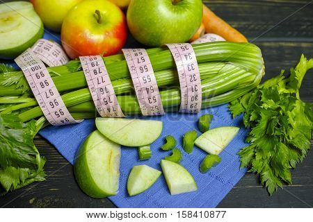 Green vegetables and fruits - celery shoots and apples healthy fitness diet concept