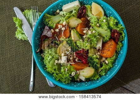 Salad with sweet potatoes dried tomatoes avocado broccoli brussels sprouts tofu mung bean sprouts. Perfect for the detox diet or just a healthy meal. Love for a healthy raw food concept.