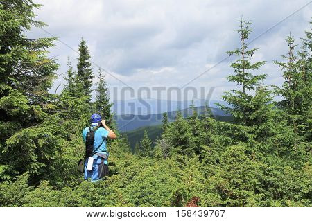 a photographer is taking pictures of mountains