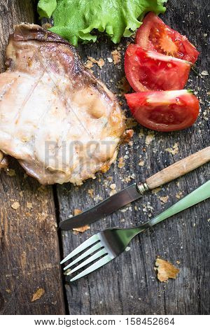 Raw beef meat.Beef steaks with vegetables and spices on a wooden floor