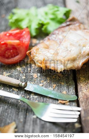Raw beef meat.Beef steaks with vegetables and spices on a wooden floor