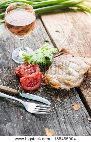 Raw beef meat.Beef steaks with vegetables and spices on a wooden floor