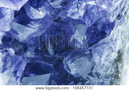 Purple amethyst stone isolated on white (rough amethyst crystals)