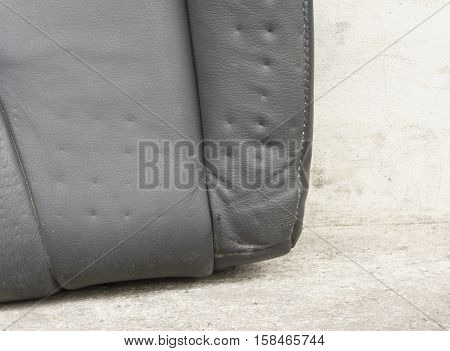 A dent pressure mark indentation on old leather vehicle car seat