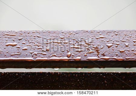 Drop of water on wood with raindrop after a rain with copy space.