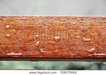 Drop of water on wood with raindrop after a rain with copy space.