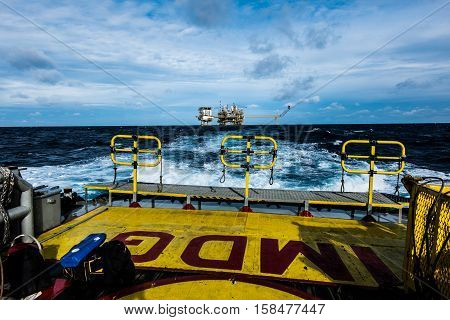 oil and gas industry and moving cargo from the boat to the platform, boat waiting transfer cargo and crews between oil and gas platform and crews boat operation in boat.
