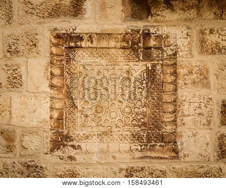 Armenian khachkar carving stone carving art on the wall in the courtyard of the Cathedral of Saint James in the Armenian Quarter of Jerusalem Israel