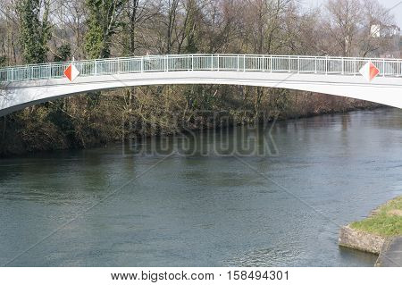 Pedestrian bridge steel arch structure over the river Ruhr in Muelheim Germany.