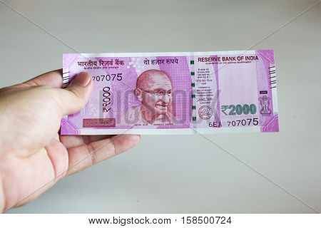 Man hold 2000 rupee banknote on white background it is the new reveal by reserve bank of India