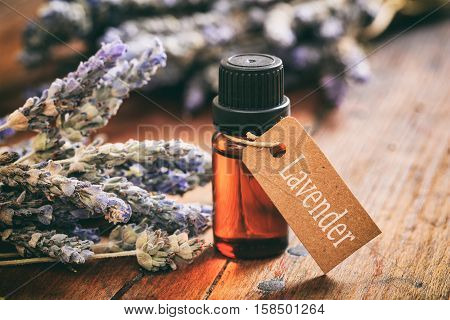 Lavender Bunch And Oil On Wooden Background